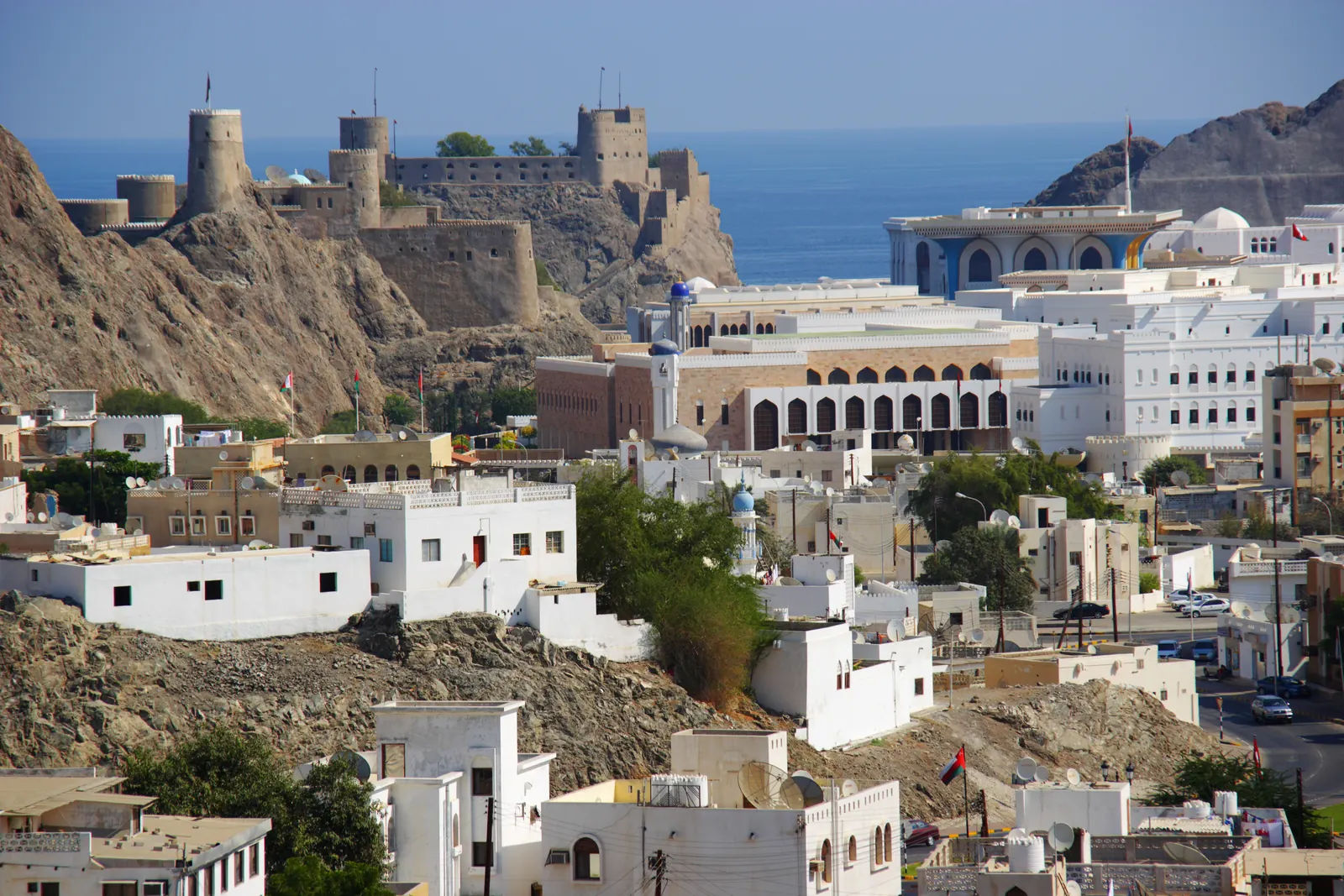 Mirani Fort on a rocky ridge above government buildings in Old Muscat, Oman
