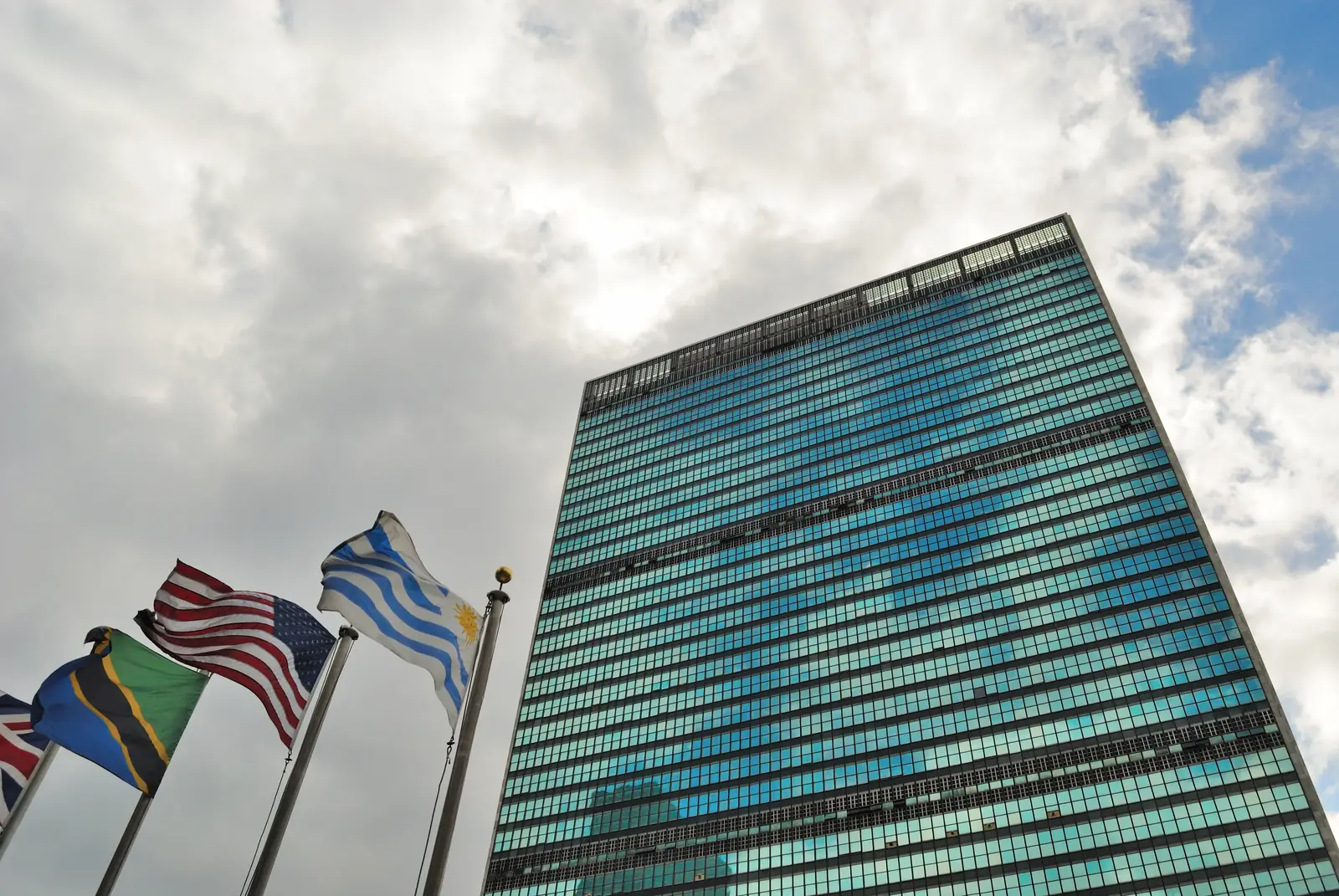 The United Nations Secretariat tower in New York, with member states' flags in front